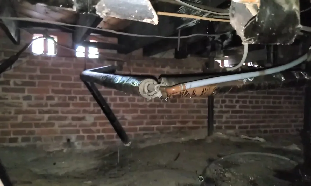 Crawl space puddle below drain piping showing the Fountain Hills Plumbing Pros service approach
